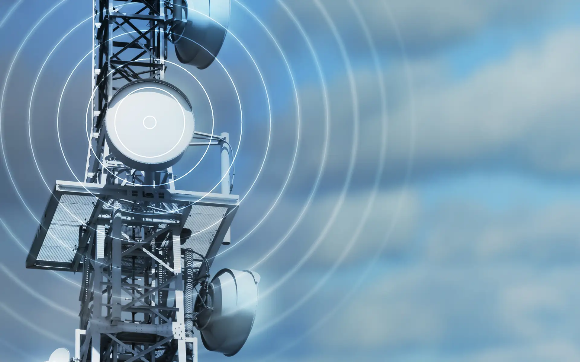 An antenna tower emitting radio waves is shown as white circles radiating outward on a cloudy sky background