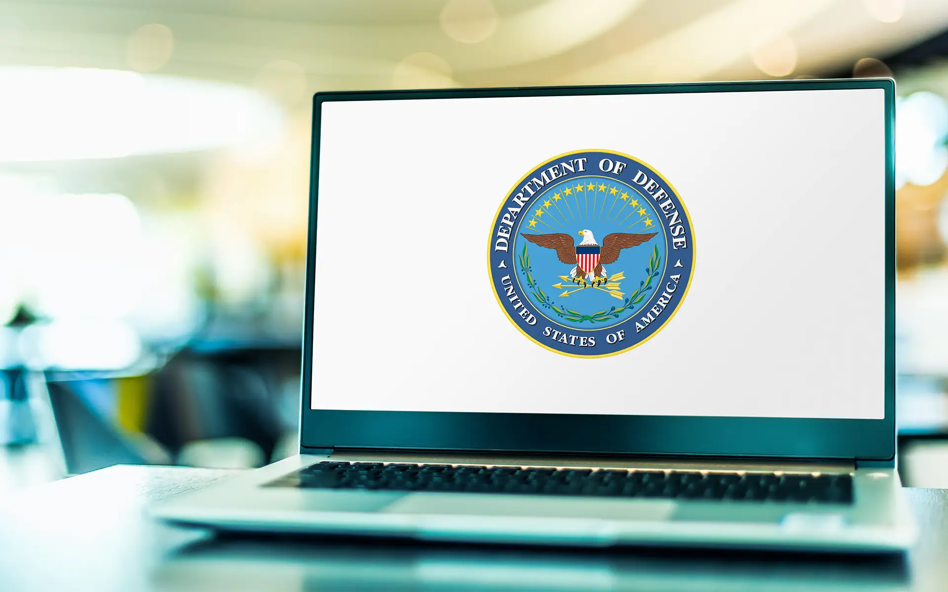 A laptop computer displaying the logo of the US Department of Defense