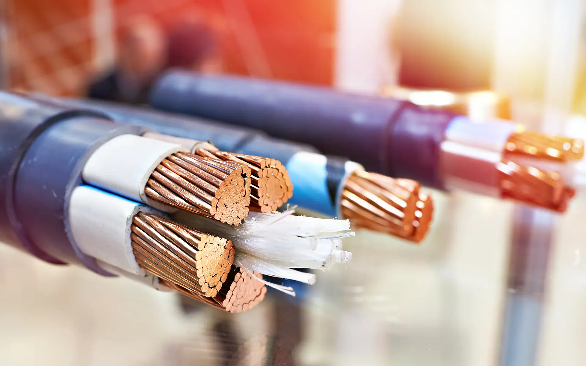 A close-up image of a large power cable with the insulation cut back to expose the interior wires and filling