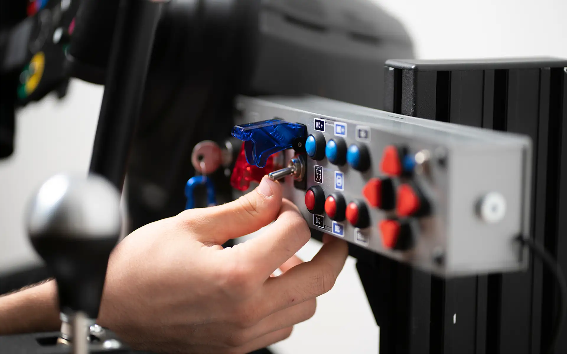 A worker flipping a toggle switch up on an industrial power control panel